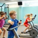 Kids using safe exercise equipment in a gym