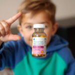 Child holding a vitamin bottle, symbolizing immune health