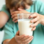 Child holding a glass of milk for bone health